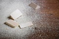 Cut pieces of wood with sawdust on brown wooden floor Royalty Free Stock Photo