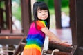 Closeup cute Asian girl is playing on net. Sweet smile child turns to look at camera. 4 years old active kid exercise. Royalty Free Stock Photo