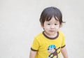 Closeup cute asian kid stand on blurred concrete street textured background with copy space Royalty Free Stock Photo