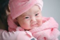 Closeup cute child care with mother indoor. Happy little toddler baby girl smiling lying on bed on white sheet at home looking at Royalty Free Stock Photo