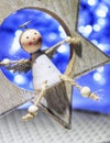 Closeup of a cute Chrismas angel ornament with blurred lights in the background Royalty Free Stock Photo