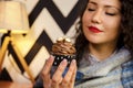 Closeup of cute curly hair girl holding cupcake