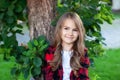 Closeup of cute little girl with long hair. Playful little girl portrait in park, smiling and playing at nature. Childhood concept Royalty Free Stock Photo