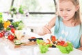 Closeup cute little girl making salad. Child cooking. Healthy food Royalty Free Stock Photo