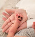 Closeup of cute newborn baby hand holding rings,mother caring palm,peaceful health concept Royalty Free Stock Photo