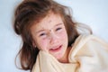 Closeup of cute sad crying little girl in bed. Varicella virus or Chickenpox bubble rash on child Royalty Free Stock Photo