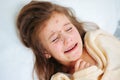 Closeup of cute sad crying little girl in bed. Varicella virus or Chickenpox bubble rash on child Royalty Free Stock Photo