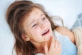 Closeup of cute sad crying little girl in bed. Varicella virus or Chickenpox bubble rash on child Royalty Free Stock Photo