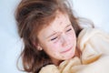 Closeup of cute sad crying little girl in bed. Varicella virus or Chickenpox bubble rash on child Royalty Free Stock Photo