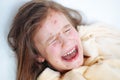 Closeup of cute sad crying little girl in bed. Varicella virus or Chickenpox bubble rash on child Royalty Free Stock Photo