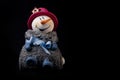 Closeup of a cute stuffed snowman toy isolated on a black background