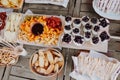 Closeup of cutting board with sandwiches, yogurt, fruits chocolate fondue tangerine, banana, kiwi, blueberries, strawberries on a Royalty Free Stock Photo