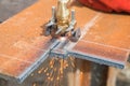 Closeup cutting plate steel with arc welder.
