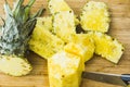 Closeup cutting a pineapple on wooden background Royalty Free Stock Photo