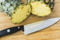 Closeup cutting a pineapple on wooden background Royalty Free Stock Photo