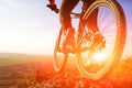 Closeup of cyclist man legs riding mountain bike on outdoor trail on hill