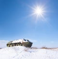 Damaged apc among snowbound plain at winter sunny day