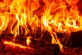 Closeup dancing burning firewood in the fireplace, fire and flames Royalty Free Stock Photo