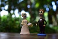 Closeup of dead people dolls getting married on the table in a garden - concept of Halloween