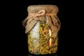 closeup decorated big glass jar with dried spices