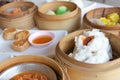 Closeup deep Chinese steamed red pork bun break can see pork inside in bamboo basket in dim sum set, Chinese restaurant food Royalty Free Stock Photo