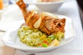 Closeup on deep fried pike fish on boiled potato pillow with butter and herbs