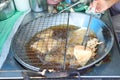 Closeup deep fried taro and tofu in the boiled oil with steel pan and tools. Vegetarian food and festival