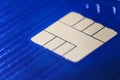 Closeup defocused view of blue plastic credit card EMV micro chip. Selective focus. Financial and Banking, Smart Payment Concept Royalty Free Stock Photo