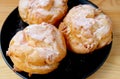 Delectable Profiterole Cream Puffs Sprinkled with Strawberry Flavored Icing Sugar