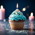 Closeup delicious birthday cupcake with burning candle on blue