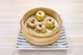 Closeup of delicious Chinese shumai dumplings on a xiaolong bamboo steaming basket Royalty Free Stock Photo