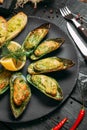 Closeup on delicious cooked mussels with sauce, lemon and garlic bread Royalty Free Stock Photo