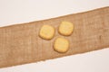 Closeup of delicious cookies laying on a natural jute sack cloth isolated on white background Royalty Free Stock Photo