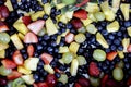 Closeup of a delicious fruit salad, with different berries, grapes, pineapples, and more Royalty Free Stock Photo