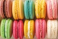 Closeup of delicious multicolored macaroons as a background. Mockup of greeting card with sweet multicolored macaron cakes.