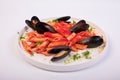 Closeup of a delicious pasta meal with tomato sauce, basil and oysters on a white background Royalty Free Stock Photo