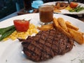 Closeup Delicious Tenderloin Stek with Potato Wedges and Mushroom Sauce Royalty Free Stock Photo