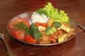 Closeup of a delicious vegetarian meal with rice, broccoli, tomatoes and lettuce on a silver plate
