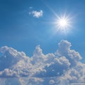 closeup dense cumulus clouds on blue sky under sparkle sun