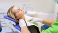 Closeup image of dentist putting protective tissue on woman patient before treatment Royalty Free Stock Photo