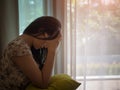 Closeup depressed woman crying while sitting alone on the floor. Royalty Free Stock Photo