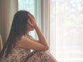 Closeup depressed woman crying while sitting alone on the floor. Royalty Free Stock Photo