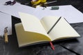 Closeup of designer`s notebook on table.Tools of designer during work.Concept of creating clothes collection Royalty Free Stock Photo