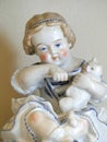 Closeup Detail of an Antique Blue and White Porcelain Trinket box a Little Girl Spoon Feeding her Cat
