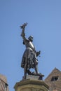 Closeup detail of a bronze statue of Lazarus von Schwendi, lord of Colmar, by his fountain near medieval timber buildings. Travel