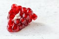 Closeup detail, cluster of red pomegranate fruits that looks like gems on white working board, space for text right