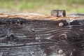 Closeup detail of a coarse weathered and broken part of a rustic wood bench with aged, cracked surface Royalty Free Stock Photo