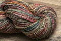 Closeup detail of colourful hand spun sheep wool merino fibres, rolled up in a yarn ball skein. Royalty Free Stock Photo