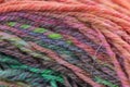 Closeup detail of colourful hand spun sheep wool merino fibres, rolled up in a yarn ball skein. Royalty Free Stock Photo