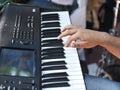 Closeup detail of a hand playing on piano keyboard Royalty Free Stock Photo